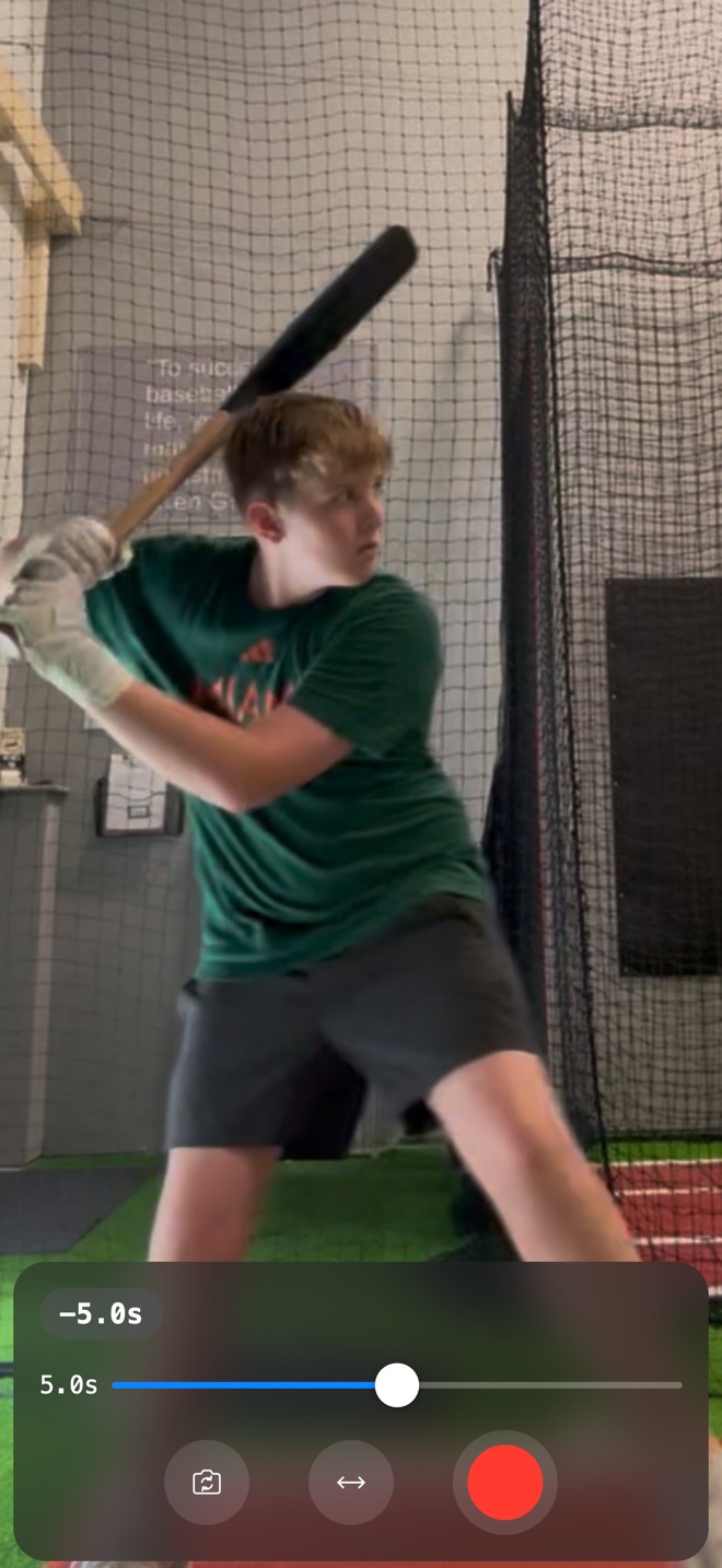 SportMirror app showing a delayed replay of a batter in a batting cage, with the delay slider set to 5 seconds